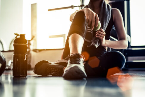 Sport woman sitting and resting after workout or exercise in fit