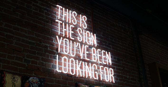 A neon sign with the message: This is the sign you've been looking for.